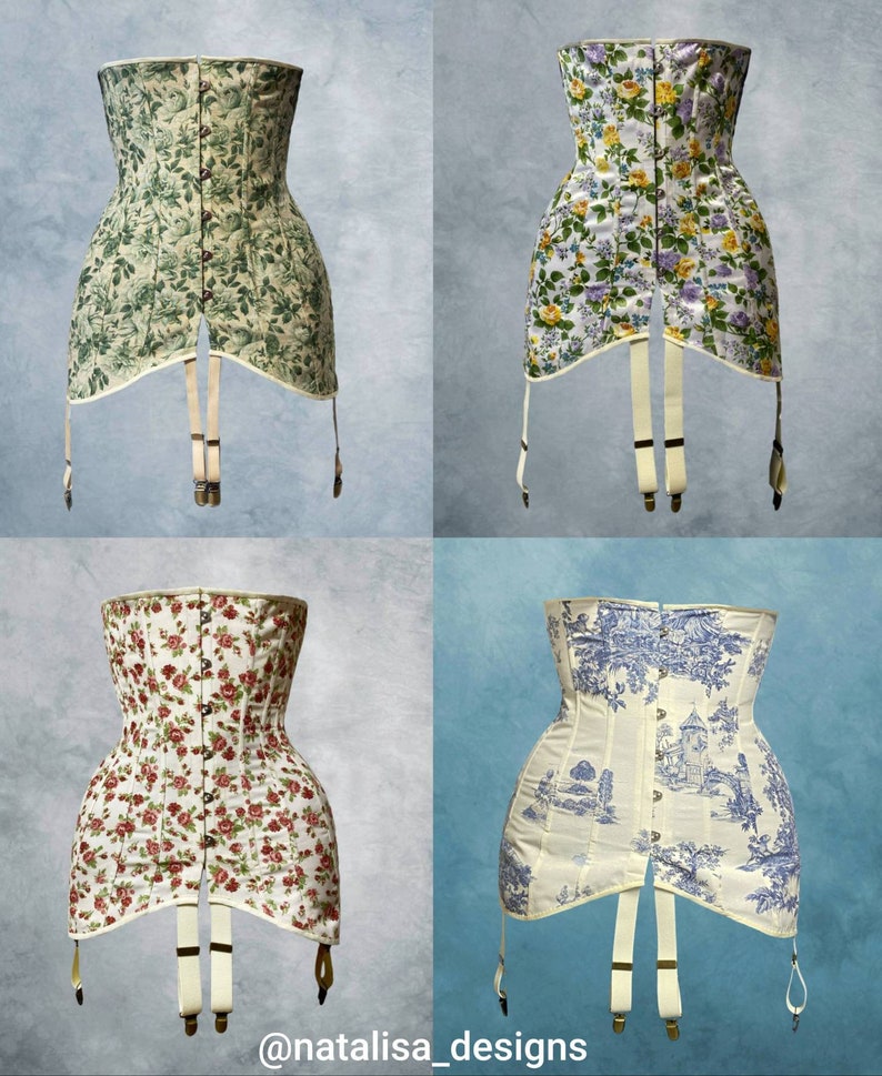 May include: Four corsets with suspenders are displayed. The corsets feature various floral patterns in green, yellow, red, and blue. One corset has a toile design. The corsets have a boned structure and are made of fabric.