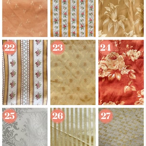 May include: A collection of fabric swatches with various patterns. The swatches include floral, striped, and textured designs in colors like gold, orange, red, and white. Some swatches feature repeating floral or geometric motifs, while others have a more abstract appearance.