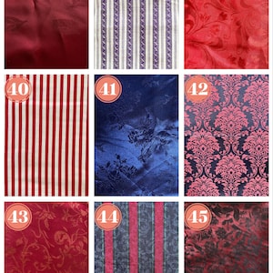 May include: A collection of fabric swatches featuring various patterns and textures. Includes a deep red leaf pattern, striped designs in purple and white, and red and white stripes. Other swatches showcase floral and damask patterns in red, blue, and black.