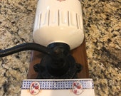 French art deco wall mounted coffee grinder, porcelain and cast iron grinder mounted on a bracket