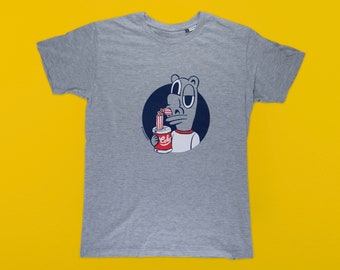 May include: A gray t-shirt with a cartoon illustration of a gray animal drinking from a red and white can with the word "Coke" on it.