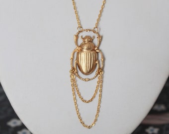 Golden necklace with Egyptian scarab pendant and chains