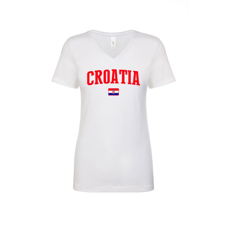 May include: White V-neck t-shirt with the word "CROATIA" in red letters and the Croatian flag printed below.
