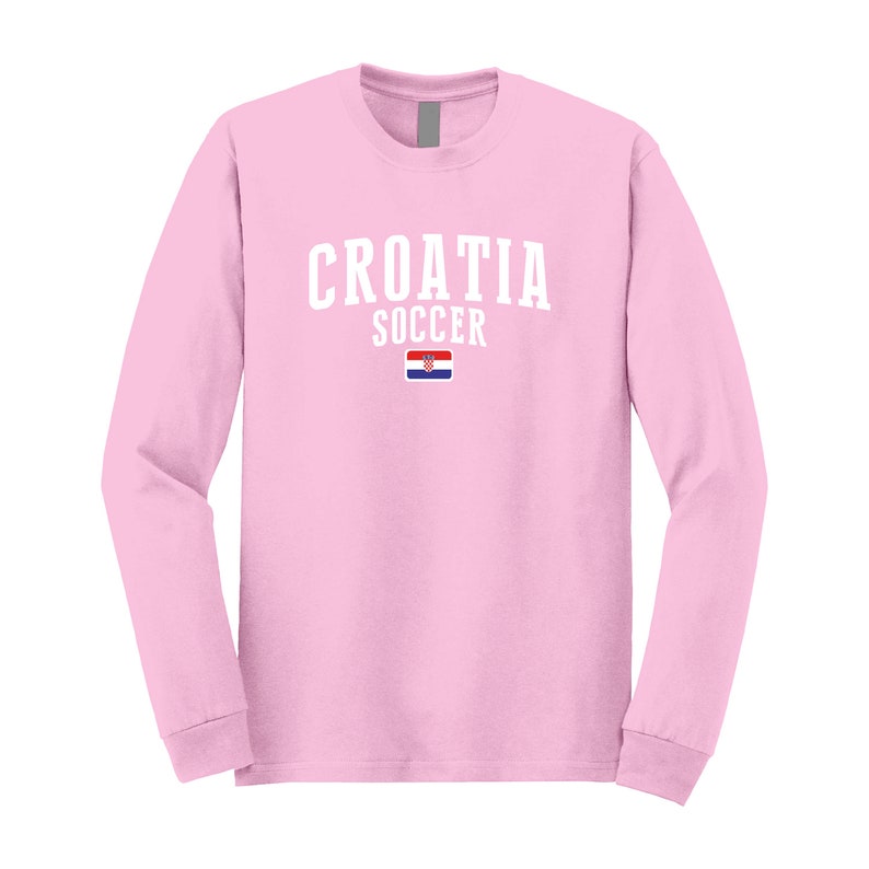 May include: Pink long-sleeve t-shirt with white text that reads "CROATIA SOCCER" and a small Croatian flag.