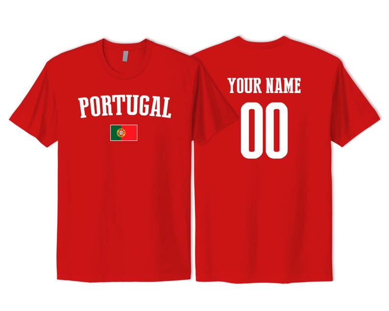 May include: A red short-sleeved t-shirt featuring the word PORTUGAL in white arched text above a small Portuguese flag on the front. The back of the shirt displays the text YOUR NAME in white above the large white numbers 00 in a block font.