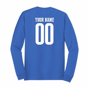 May include: A royal blue long-sleeved t-shirt with "YOUR NAME" and the number "00" printed on the back in white.