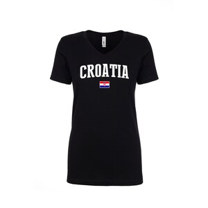 May include: Black v-neck t-shirt with the word "CROATIA" in white letters and the Croatian flag printed on the front.