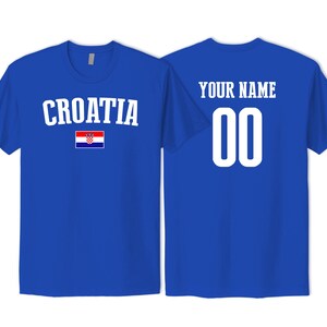 May include: A royal blue t-shirt featuring the word CROATIA in white text above a small Croatian flag on the front, and the words YOUR NAME above the number 00 in white text on the back, showcasing a customizable sports jersey design.