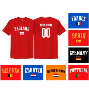 May include: A red short-sleeved t-shirt featuring the word ENGLAND and a flag on the front, with YOUR NAME and the number 00 on the back. The image also displays various country names and their respective national flags in rectangular boxes.