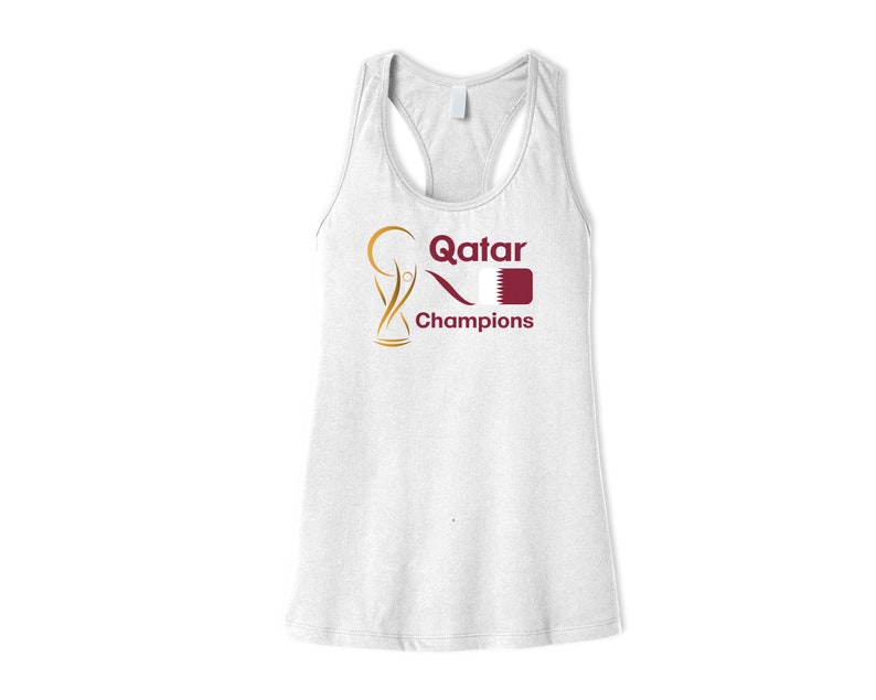 May include: White tank top with a gold and maroon graphic of a trophy, the word "Qatar", and a flag. The text "Champions" is below the graphic.