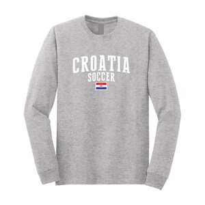 May include: A gray long-sleeve t-shirt with the text "CROATIA SOCCER" in white and the Croatian flag printed on the front.