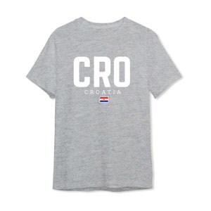 May include: A gray t-shirt with the word "CRO" in white letters and the word "CROATIA" below it. The Croatian flag is displayed below the word "CROATIA".