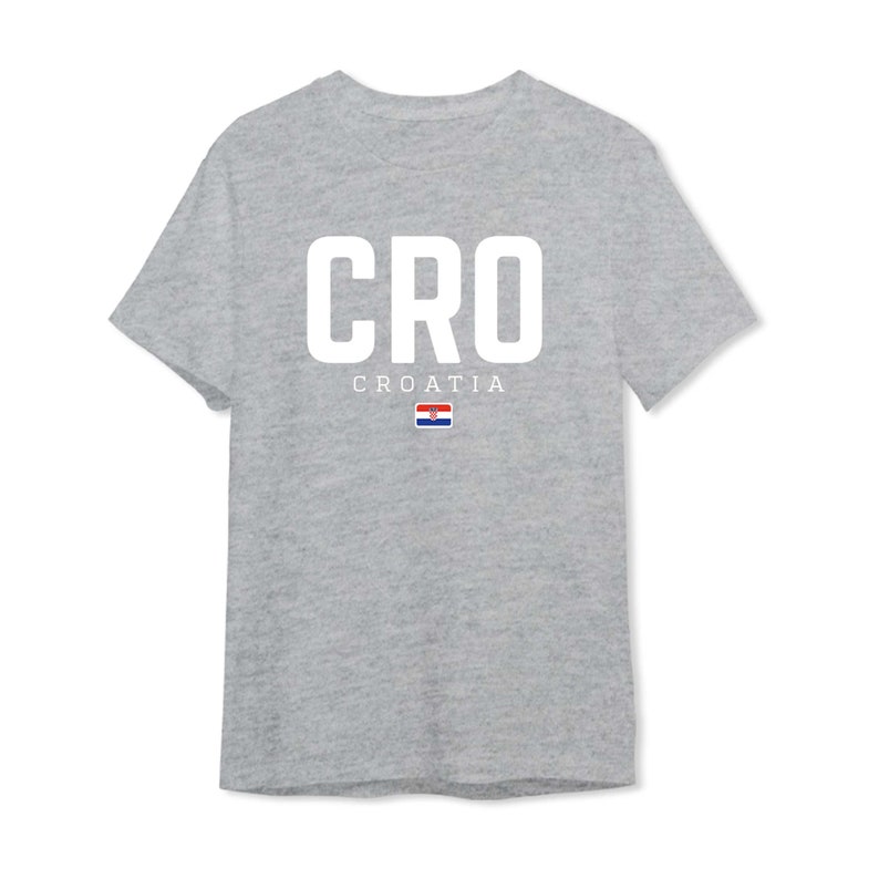 May include: A gray t-shirt with the word "CRO" in white letters and the word "CROATIA" below it. The Croatian flag is displayed below the word "CROATIA".