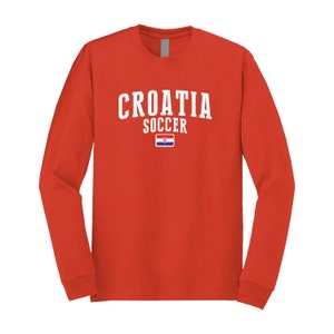 May include: Red long-sleeve t-shirt with white text that says "CROATIA SOCCER" and a small Croatian flag.