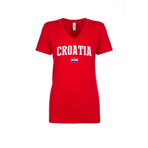 May include: Red V-neck t-shirt with the word "CROATIA" in white letters and the Croatian flag printed on the front.