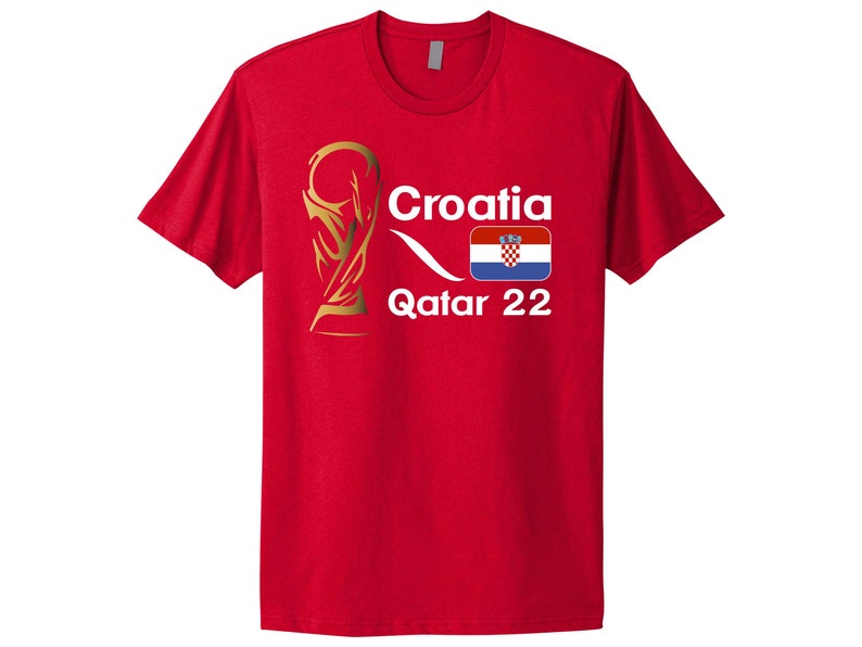 May include: Red t-shirt with a white graphic of a gold trophy, the word "Croatia", the Croatian flag, and the text "Qatar 22".