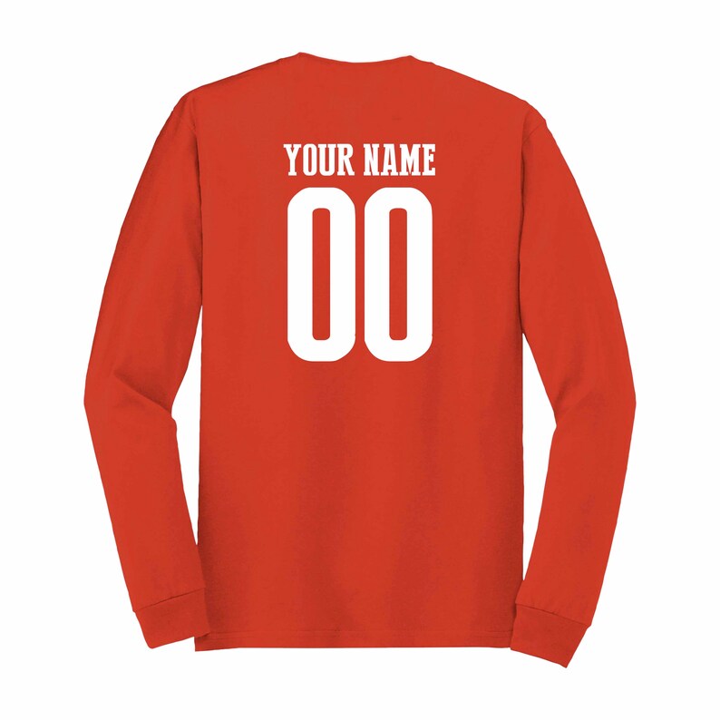 May include: Red long-sleeve shirt with white text that says "YOUR NAME" and the number "00" on the back.