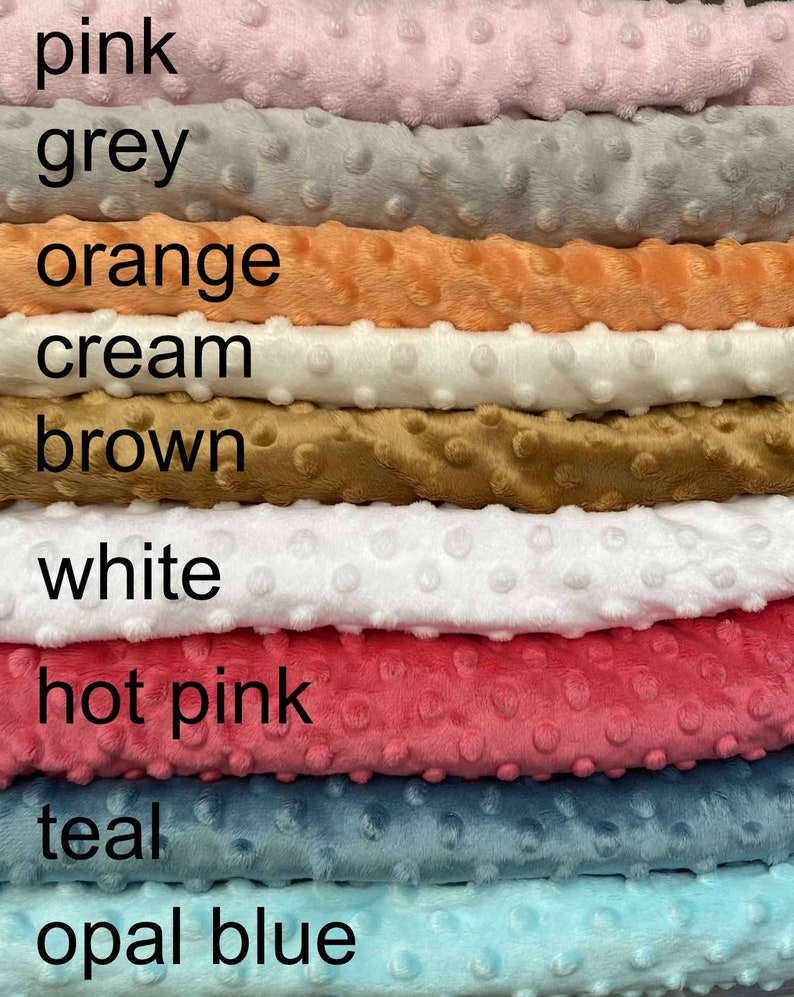 May include: A stack of eight different colours of soft, textured fabric. The colours are pink, grey, orange, cream, brown, white, hot pink, teal, and opal blue.