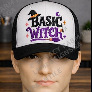 May include: A white and black trucker hat featuring an embroidered design on the front panel. The embroidery displays the text "BASIC WITCH" in black and purple, accompanied by a black witch hat, a purple broom, a small crescent moon, and stars.