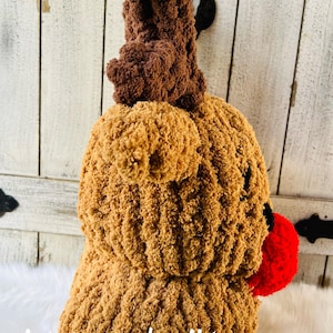 May include: A handmade, plush reindeer head in shades of brown with a red nose. The reindeer has large, textured antlers and a fluffy body. The text "stacey made it!" is visible at the bottom of the image.
