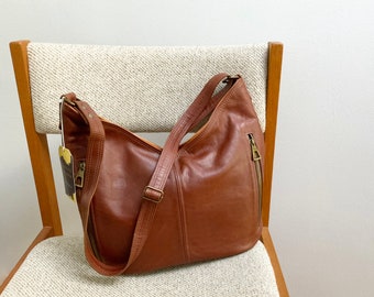 Hand made in Canada chocolate brown and tan glove tanned leather with a water proof lining and casual bag for women