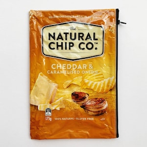 May include: A yellow bag of The Natural Chip Co. Cheddar & Caramelised Onion potato chips. The bag is 175g and 100% natural and gluten free.
