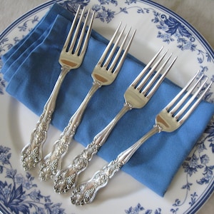 May include: A set of three ceramic mugs with a speckled, matte finish. The mugs are in shades of cream, light gray, and dark gray. Each mug has a simple, minimalist design, perfect for coffee or tea.