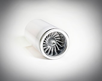 May include: A silver model of a jet engine with a visible fan blade.