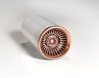 May include: A white and rose gold colored jet engine model. The engine is made of plastic and has a detailed design.