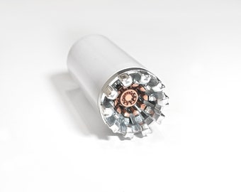May include: A silver and copper colored metal object with a cylindrical body and a starburst-shaped end. The object has a white background.