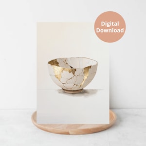 Op de afbeelding: Digitale download print van een witte keramische kom met goudkleurige kintsugi-stijl reparaties. De kom staat tegen een neutrale achtergrond, met een houten dienblad op de voorgrond. De print heeft een minimalistische esthetiek.