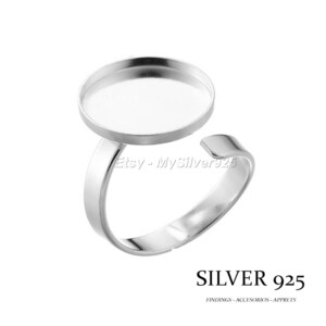 Puede incluir: Anillo de plata con un engaste redondo para un camafeo u otro adorno. El anillo es ajustable y está hecho de plata de ley.