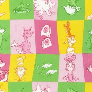 May include: A colorful fabric featuring a repeating pattern of whimsical characters and objects in a grid of pink, green, and yellow squares. The illustrations are outlined in white and include a cat in a hat, fish, and other Dr. Seuss-inspired designs.
