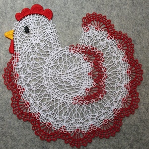 May include: White crocheted chicken doily with a red border. The chicken has a red comb and a yellow beak.