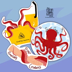 May include: Three colorful stickers featuring an octopus. One sticker shows an octopus wrapped around a yellow bucket with the text "Sowell Bay Aquarium". Another sticker shows an octopus in a blue circle with the text "Smart Cookie". The third sticker shows an octopus wrapped around a hand with the text "Remarkably Bright Creatures".