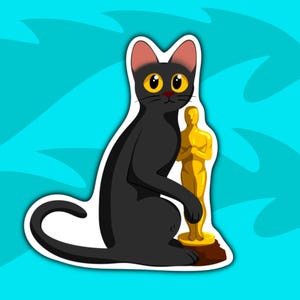 May include: A black cat with yellow eyes sits holding a gold Oscar statue. The cat is looking at the viewer.