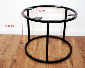 May include: Black metal table base with a round top measuring 60 cm in diameter and a height of 43 cm. The base has a simple, modern design with a circular top and four legs.