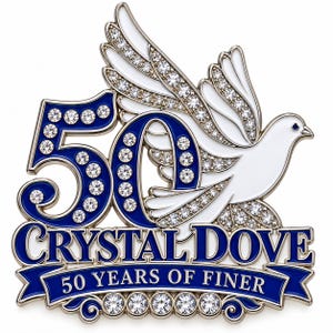 May include: A decorative metal emblem featuring the number 50 in blue enamel with embedded clear crystals. A white enameled dove is positioned behind the number. Below, a blue banner displays the text CRYSTAL DOVE and 50 YEARS OF FINER.