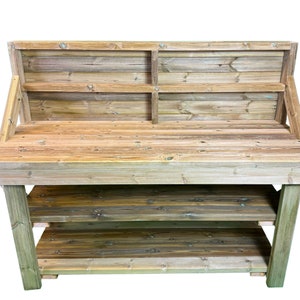 May include: A wooden workbench with a backboard, two shelves, and a work surface. The workbench is made of natural wood with a rustic finish.