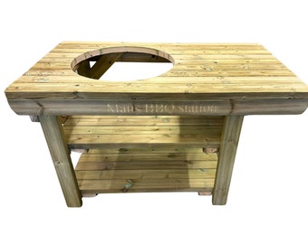 May include: Wooden outdoor BBQ station with two shelves and a round cutout for a grill. The station is made of natural wood and has a rustic look. The text "Mats BBQ station" is engraved on the front.