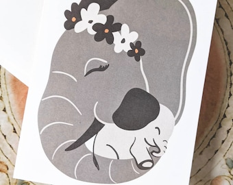 Greeting Card | Baby Elephant // Gray elephant mom with orange flower crown rocks baby elephant to sleep. // New Mom/ New Baby/ Mother's Day