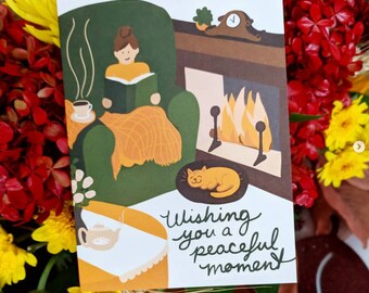 Greeting Card | Peaceful Moment // Person with messy bun reading and drinking coffee/tea in a cozy chair, cat, blanket, autumn, orange,