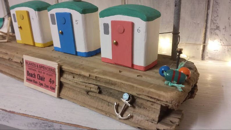 Driftwood art colourful beach huts on the beach