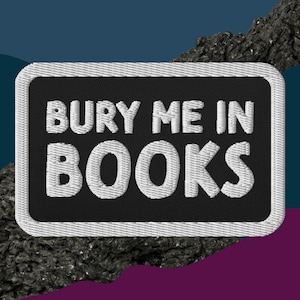 May include: Black and white embroidered patch with the text "BURY ME IN BOOKS" in white lettering.