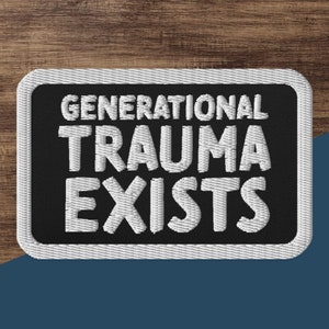May include: Black and white embroidered patch with the text "GENERATIONAL TRAUMA EXISTS" in white lettering.