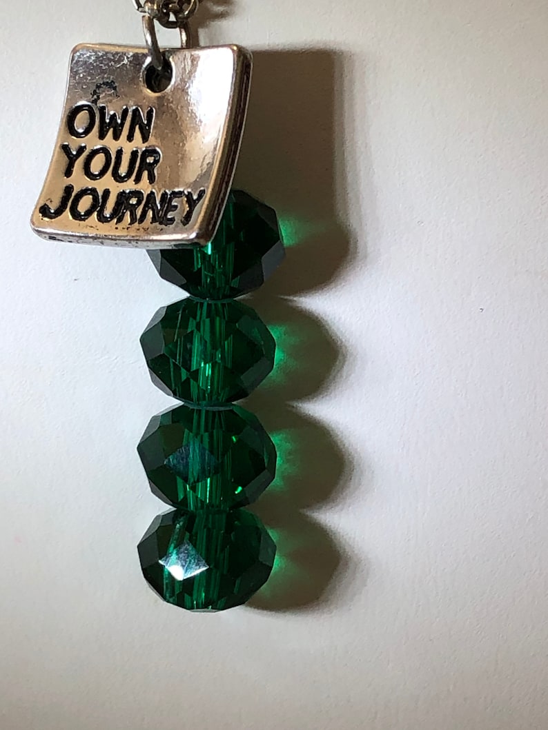Green glass beads with a little note