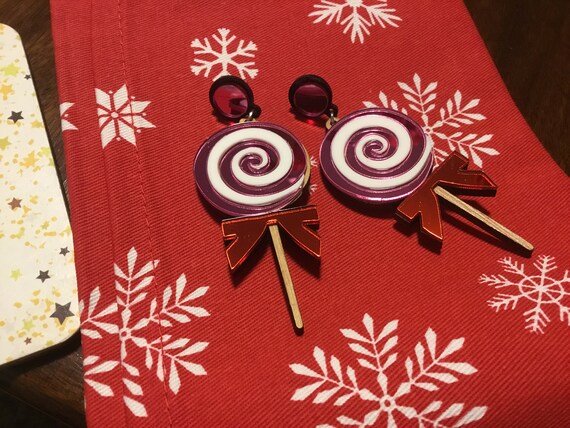 Acrylic mirror lollipop candy earrings on wood
