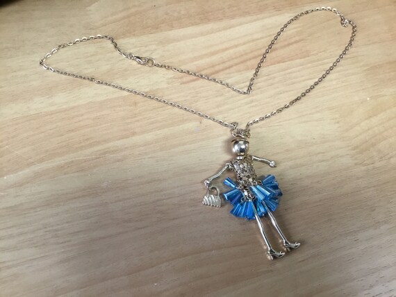 Doll necklace goldtone with bead skirt