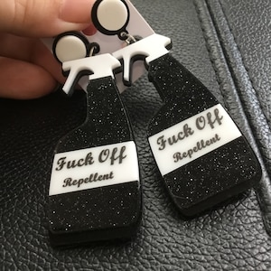 Novelty f*** o** repellant earrings black glitter detail