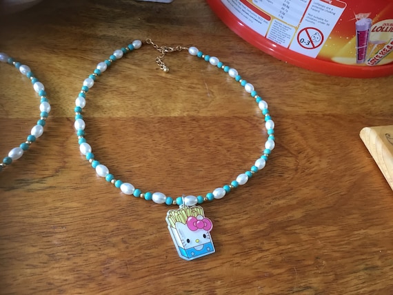 Necklace with kitty fries charm attached
